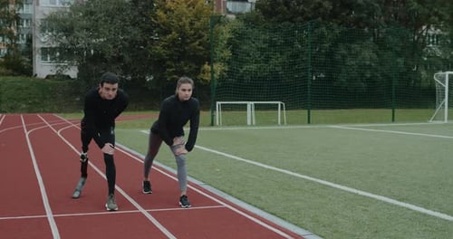Athletic Man with Prosthetic Leg Running with Woman