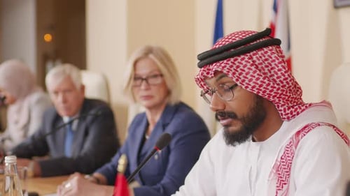 People in a Meeting at a Long Conference Table