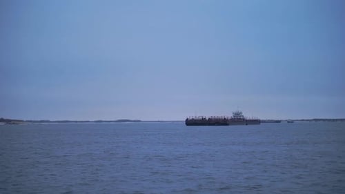 Barge Floating on River on Cloudy Day