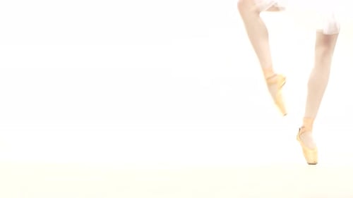 Young Ballerina Dancing, Closeup on Legs and Shoes, Standing in Pointe Position.