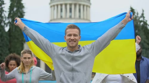 Group Holding Flag in Urban Setting