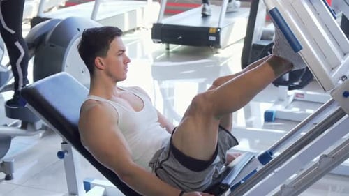 Male Doing Leg Press Exercise at Gym