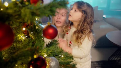 Two Sisters Helping Mother Decorating Christmas Tree