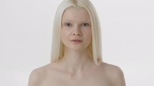 Striking Woman with Long Blonde Hair in Studio