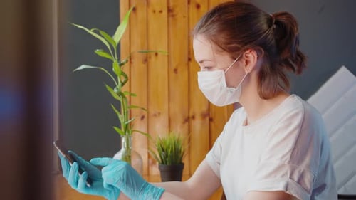 Woman with Mask and Gloves Waving on Smartphone