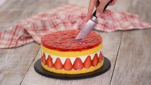 Slicing Fresh Strawberry Cake in Home Setting
