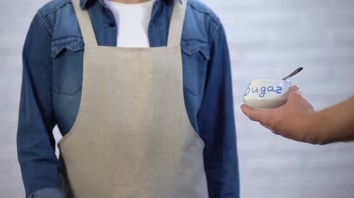 Person in Apron Gesturing No Sugar in Cooking, Risk of Diabetes and Obesity