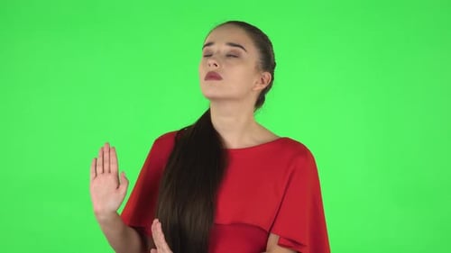 Young Woman Gesturing Stop on Green Background
