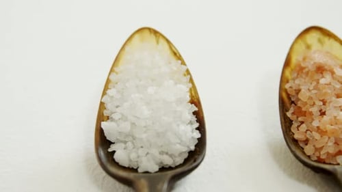 Various types of sea salt in a spoon 4k