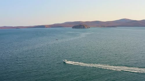 The Motorboat Moves Quickly Across the Sea and Splashes in the Waves