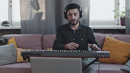 Man Plays Keyboard at Home, Indoors