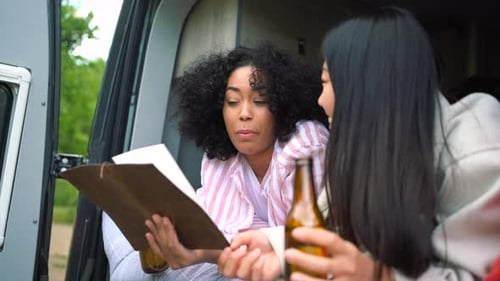 Two Friends Chatting in a Camper Van