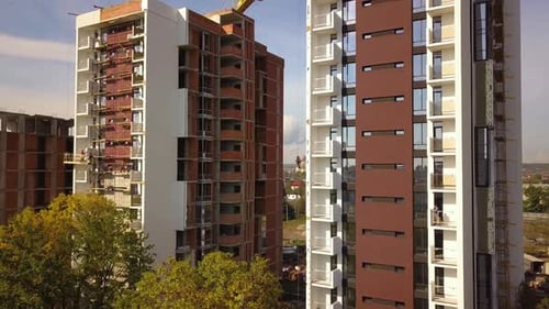 Aerial view of high residential apartment buildings under construction. Real estate development.