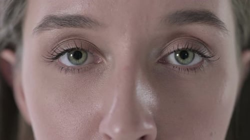 Close Up of Young Woman Face with Blinking Eyes