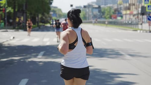 Woman Running Street Race in Slow Motion