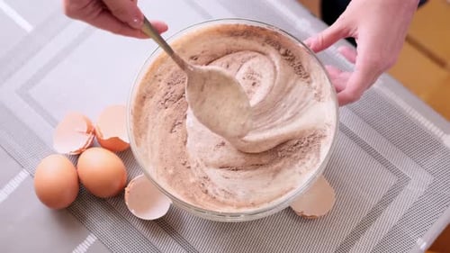 Adding Flour and Cocoa to Beaten Eggs Making Dough for Baking