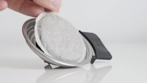 Coffee Pod Placed in Silver Coffee Maker Filter
