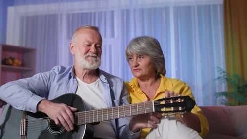 Senior Couple Playing Guitar and Singing Together