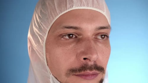 Adult Puts on Face Mask Wearing Protective Suit