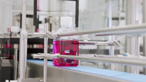 Automated pharmaceutical manufacturing line, bottles filled with liquid