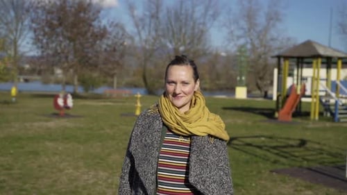 Pregnant woman holding the belly in public playground, Zagreb, Croatia.