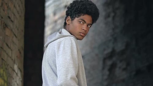 Lonely afro-american millennial walking abandoned place