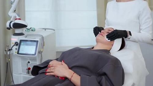 Cleaning Facial Skin Before Laser Therapy at Cosmetology Clinic