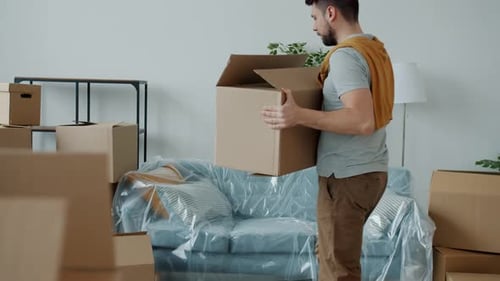 Slow Motion of Man Carrying Boxes To New House Then Touching Back Feeling Pain