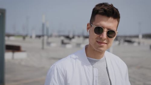 Smiling Young Adult Wearing Sunglasses Outdoors