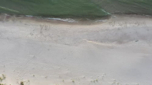 AERIAL: Descending Top View Shot of Sandy Beach with Seashore and Baltic Sea Seaside