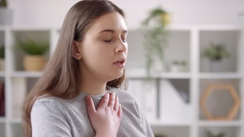 Woman Using Inhaler for Asthma Treatment
