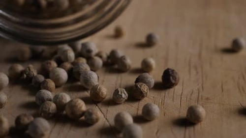 close up pepper grains on wood table