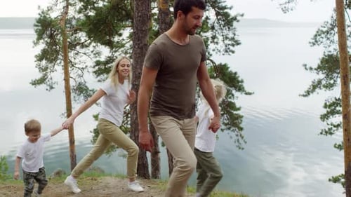Family Walking by Scenic Lake