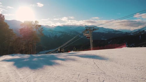 Winter Mountains Panorama with Ski Slopes and Ski Lifts on a Sunny Day.