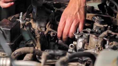 Close Up Shot of the Mechanic Repairs the Engine in (UHD)