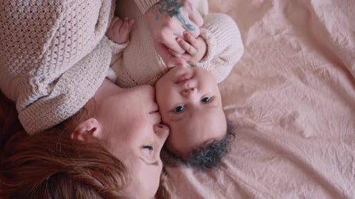 Mother and Baby Smiling, Lying Head to Head