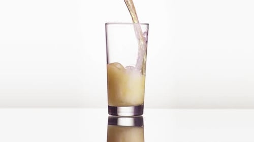 Beer Being Poured Into Glass Overflowing With Foam