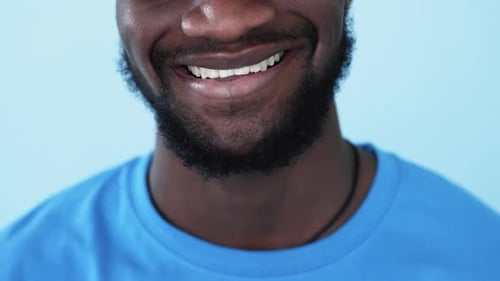 Man With Black Beard Smiles Close Up