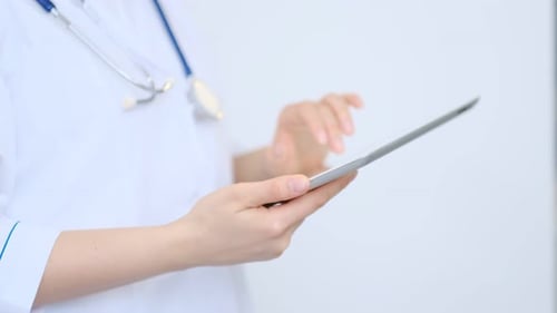Doctor Using Tablet in Hospital Setting