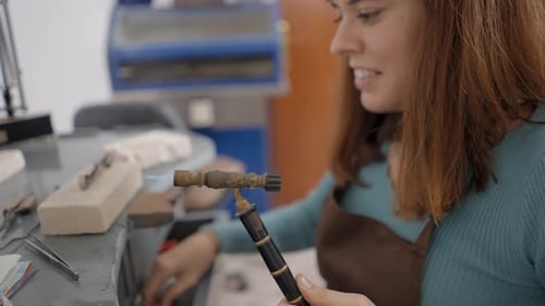 Female Jeweler Holding Gas Blowtorch Crafting In Workshop