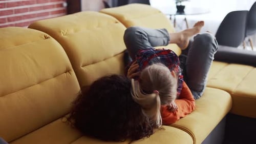 Mother and Child Play Together on Couch