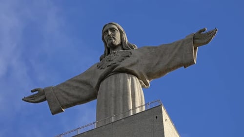 Christ King Statue Against a Blue Sky with Clouds