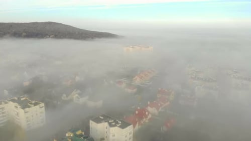 Aerial View at the Houses That Are Covered with Morning Fog. Flight Over the City of Lviv in Ukraine