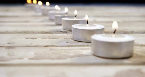 Burning candles on wooden plank 4k