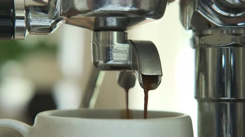 Coffee Dripping from Espresso Machine Close Up