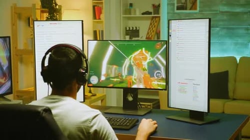 Young Adult Gamer Playing Video Game At Home