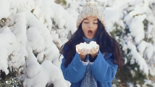Happy Winter Girl Playing with Snow in Park Outdoors
