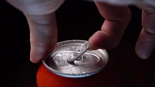 Opening Refreshing Soda Can with Water Droplets