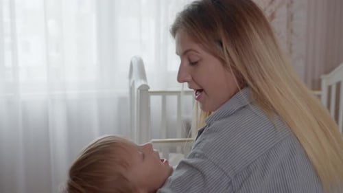 Mother and Child Cuddle Indoors