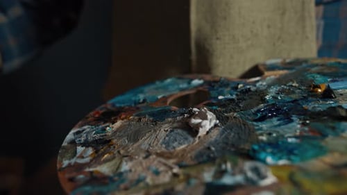 Artist Paints an Oil Painting in a Studio Painter at Work
